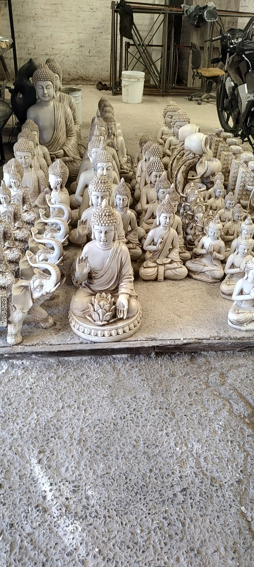 Un montón de estatuas están sentadas sobre una mesa en una habitación.