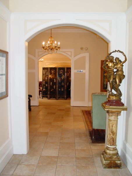 a hallway with a statue in the middle of it