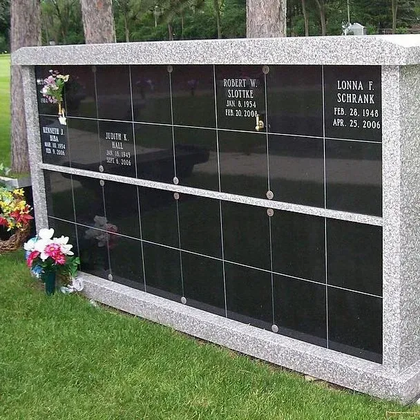 a cemetery with flowers and a wall that says lona e schrane on it