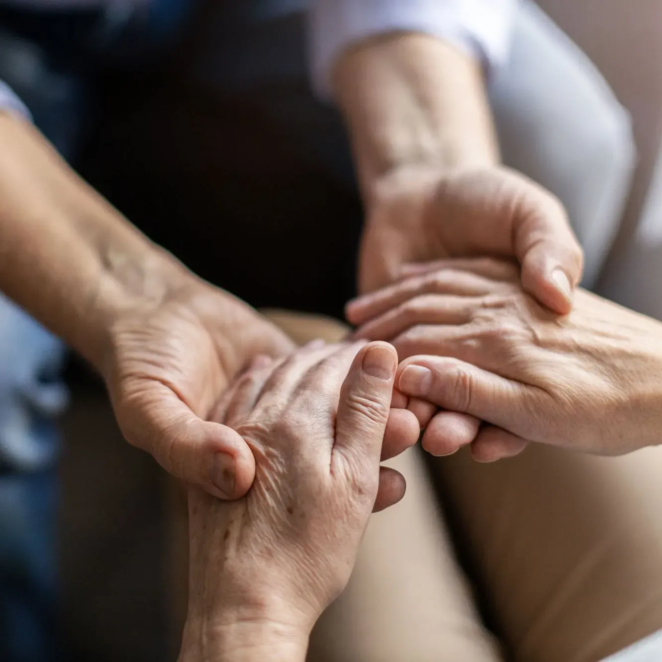 two people holding hands close up
