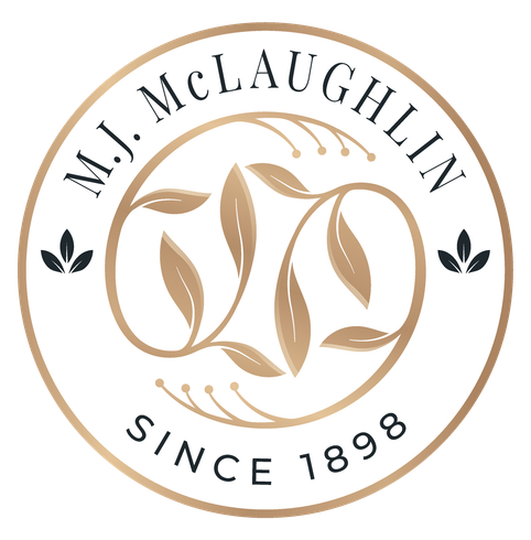a logo for mj mclaughlin since 1898 with leaves in a circle .