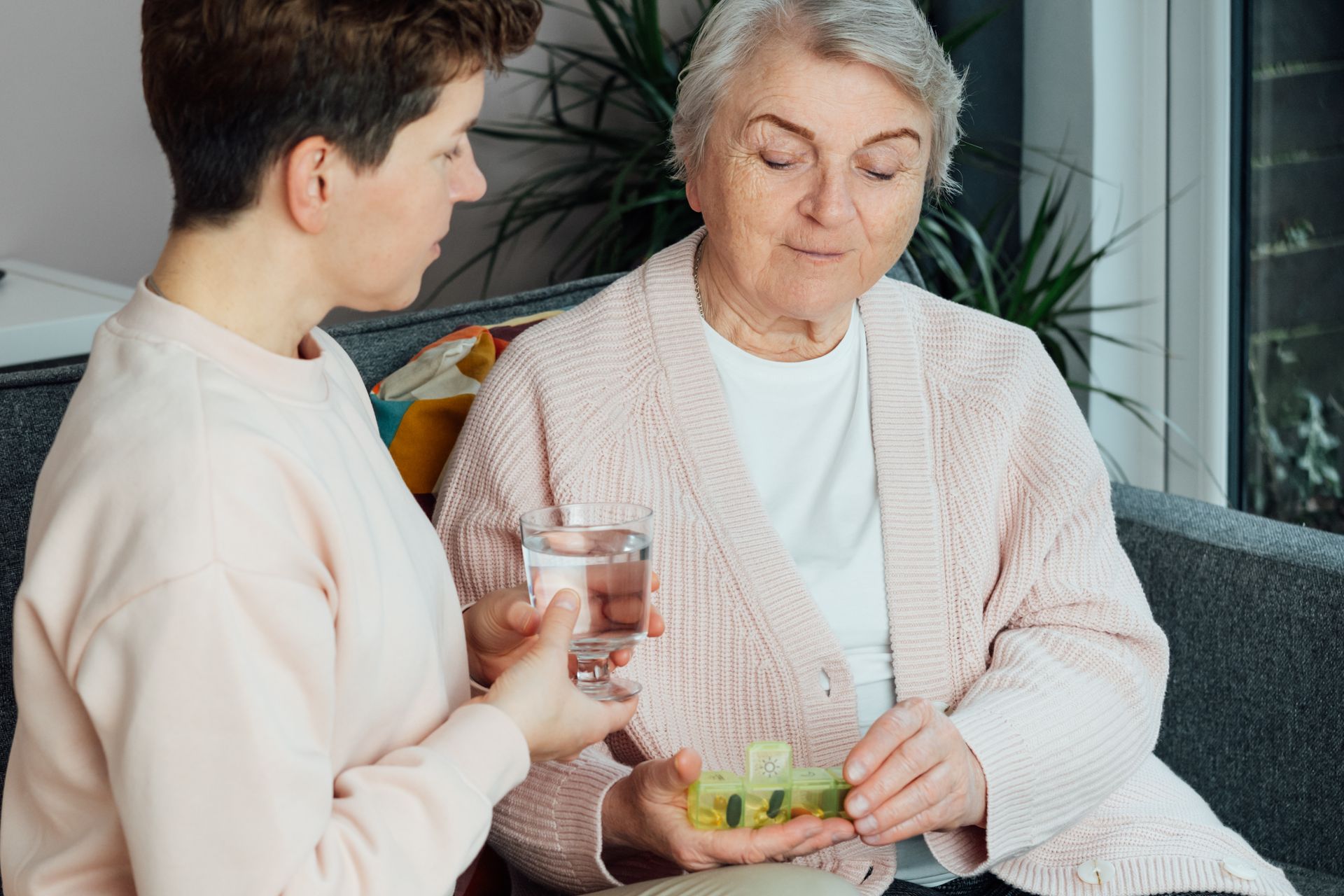A doctor is taking notes on a clipboard while talking to a soldier.