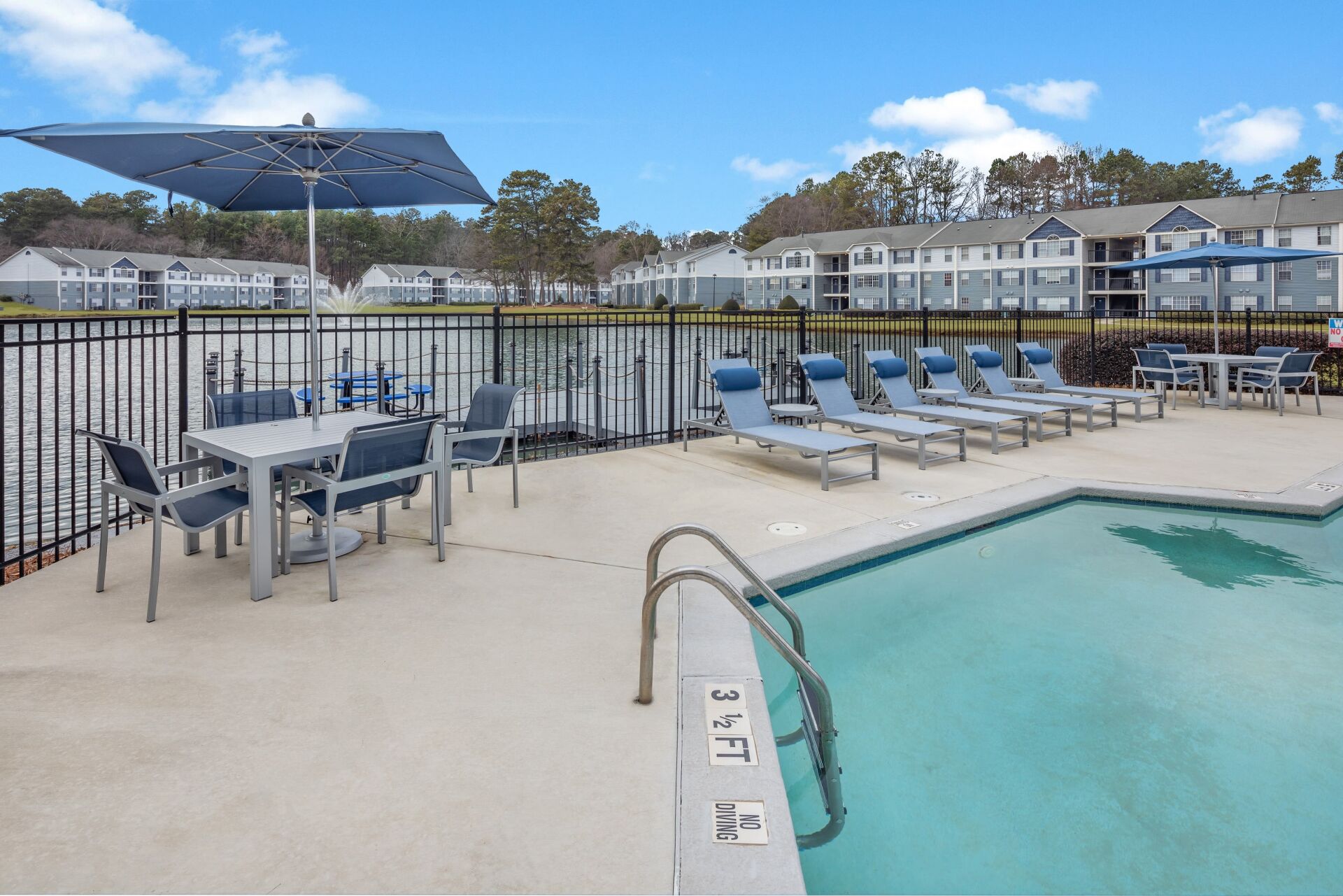 The Bentley at Marietta | Apartment Pool Area with Lounge Chairs