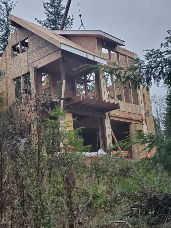 A house that is being built with a crane in the background