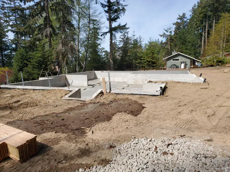 A house is being built in the middle of a dirt field