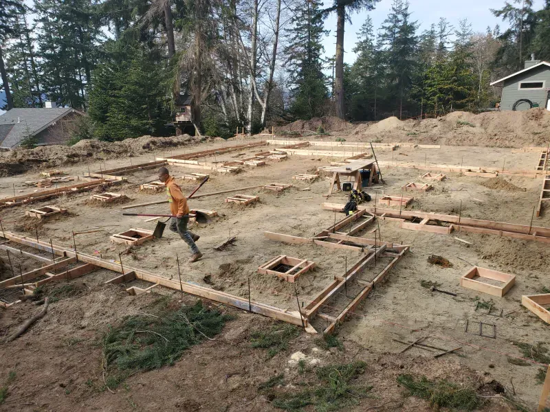 A man is standing in the middle of a construction site.