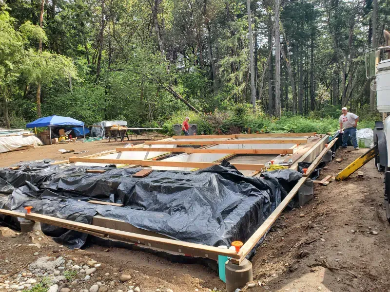 A building is being built in the middle of a forest.