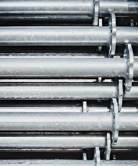A Close Up Of A Row Of Metal Pipes Stacked On Top Of Each Other — ARK Plumbing & Gasfitting In Exeter, NSW
