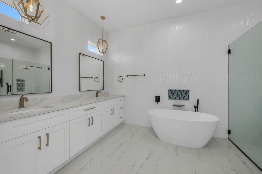 A bathroom with two sinks , a tub , and a shower.