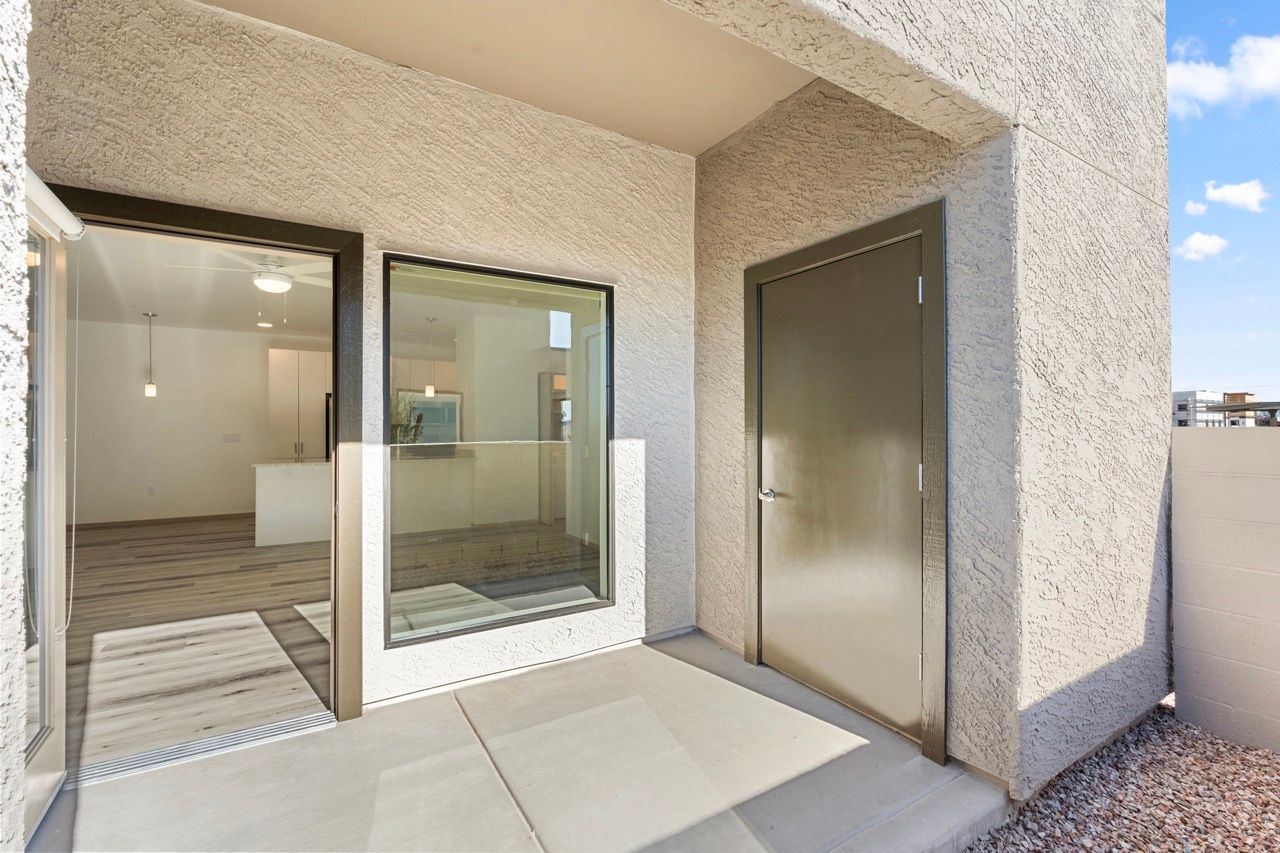 Balcony with sliding glass door opening to a modern apartment interior.