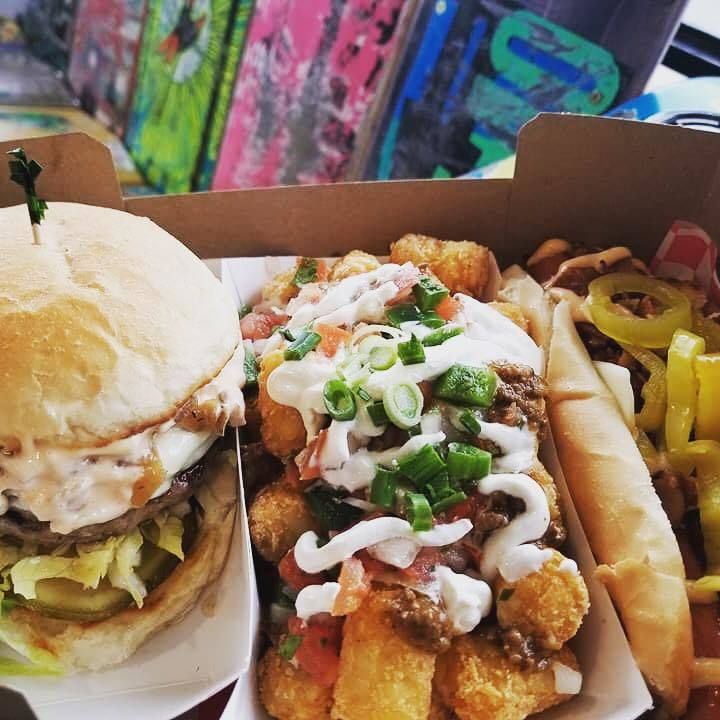 A hamburger and a hot dog are in a cardboard box