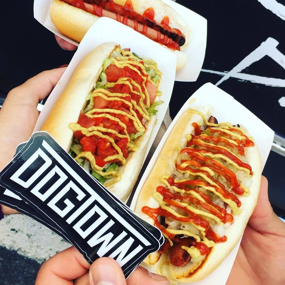 A person holding a sticker that says dogtown on it