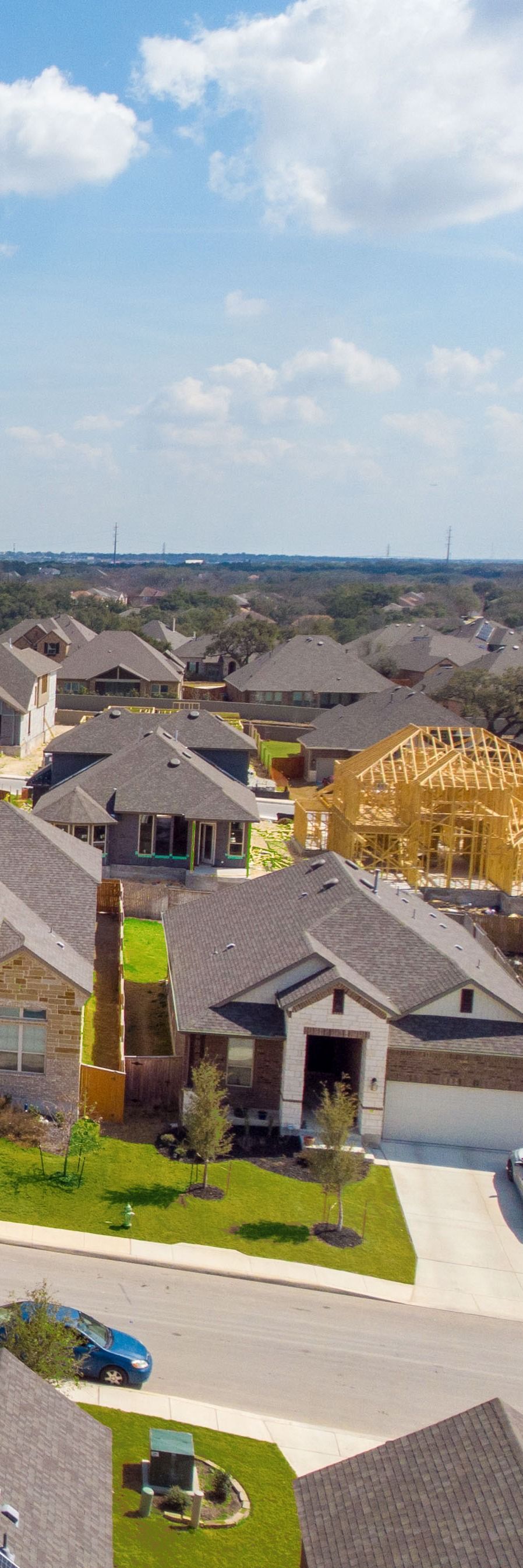 A large white house with a palm tree in front of it.