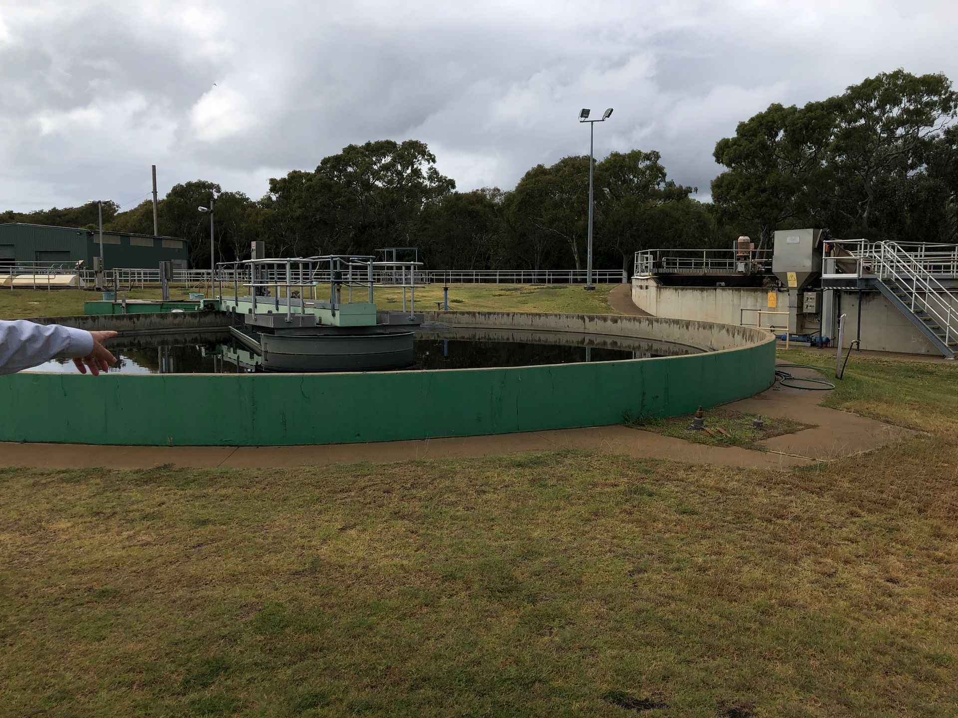 A man is standing in front of a large tank of water