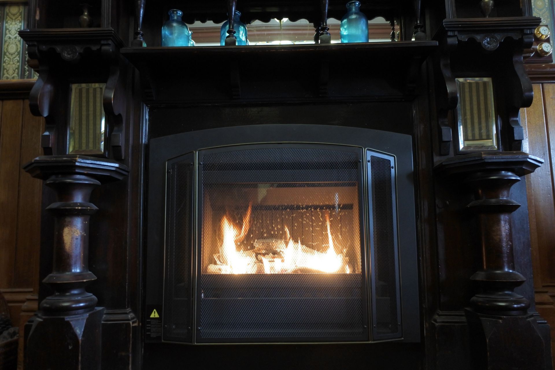 There is a fireplace with a lot of fire in it.