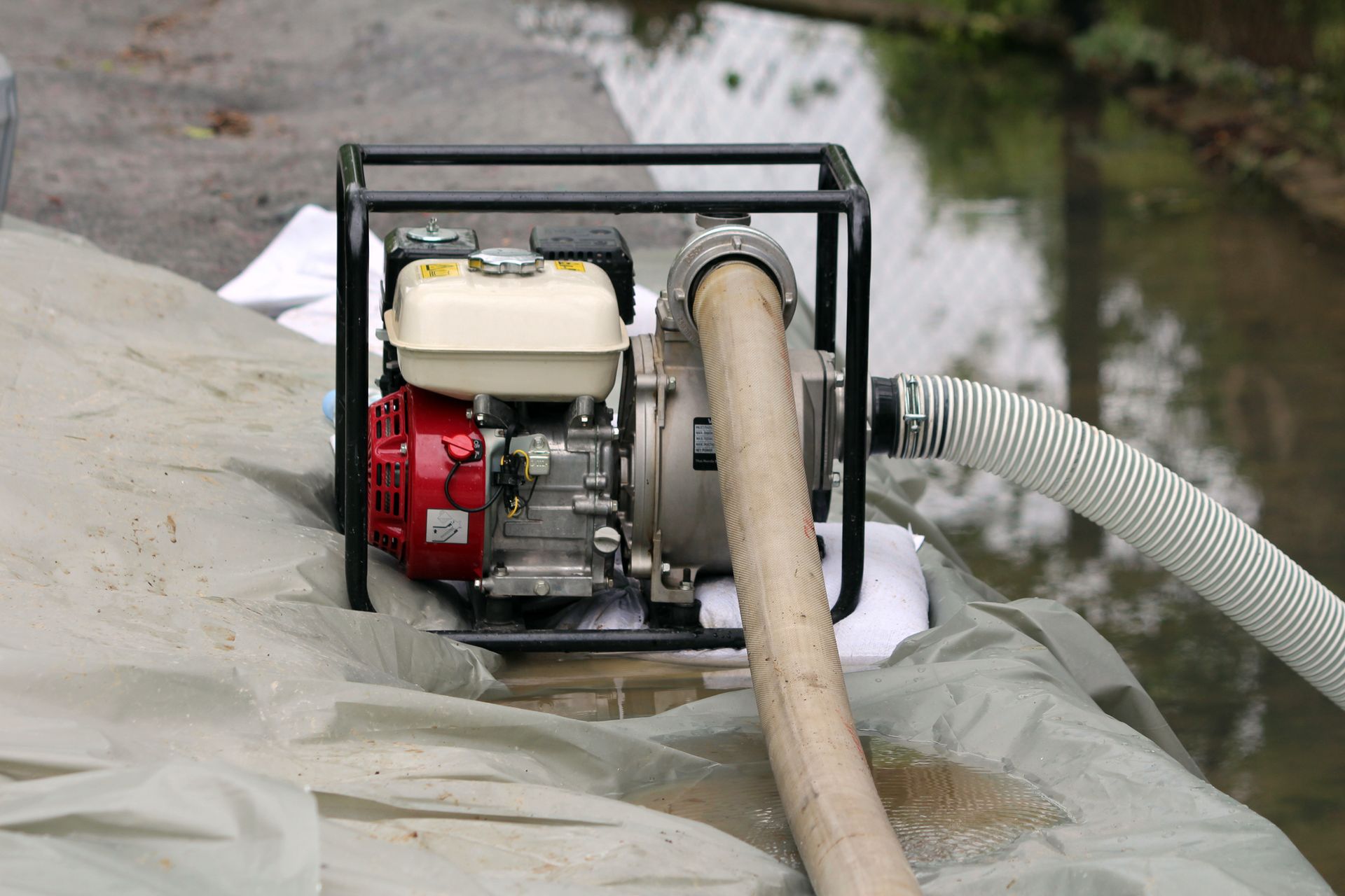 A water pump with a hose attached to it.
