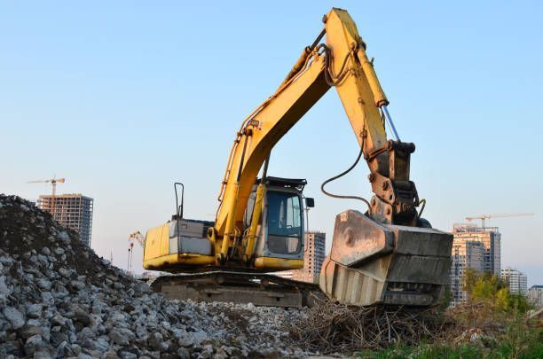 A yellow excavator is working on a construction site.