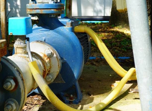 A blue pump with a yellow hose attached to it