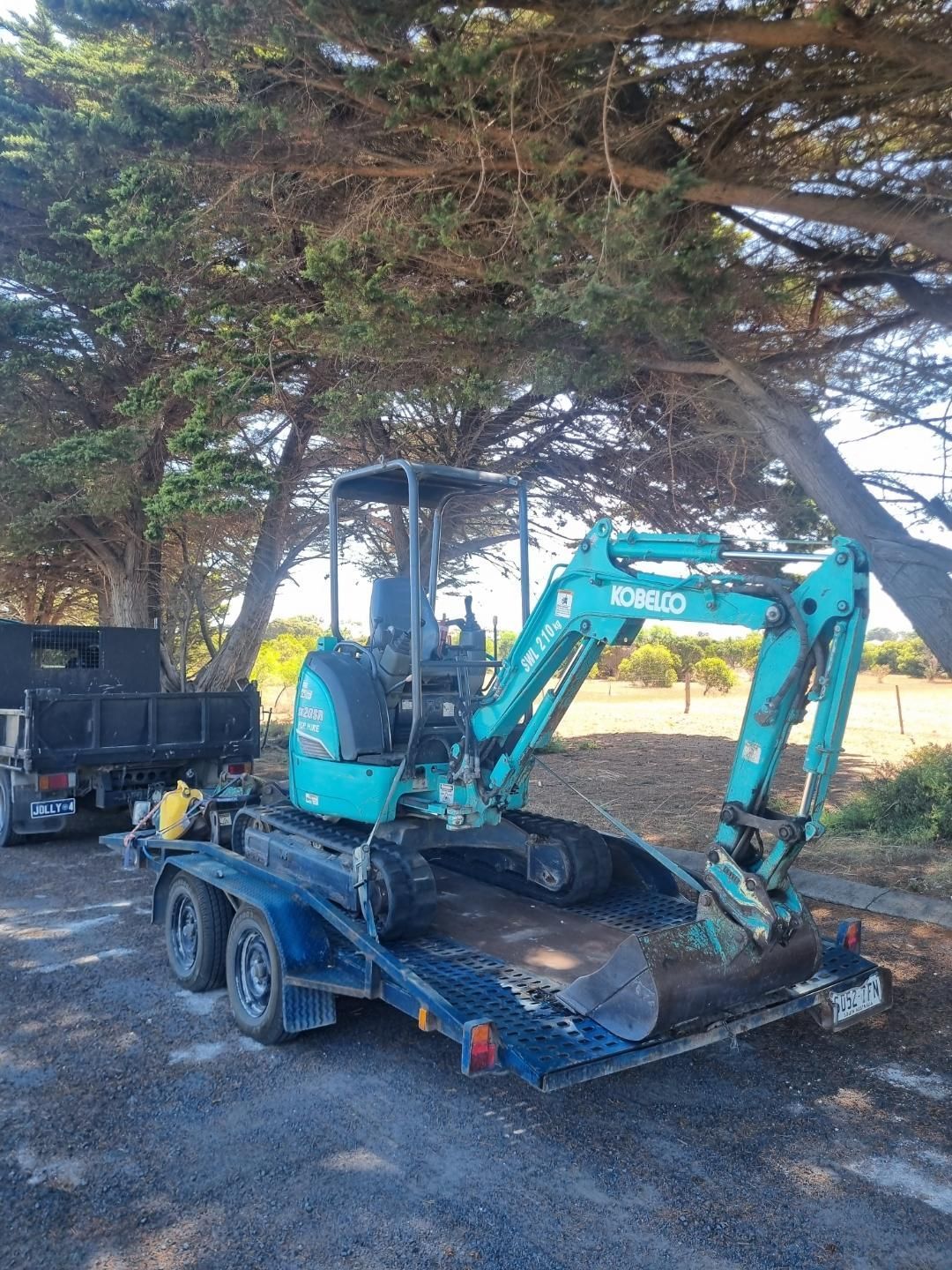 A yellow excavator is working on a construction site.