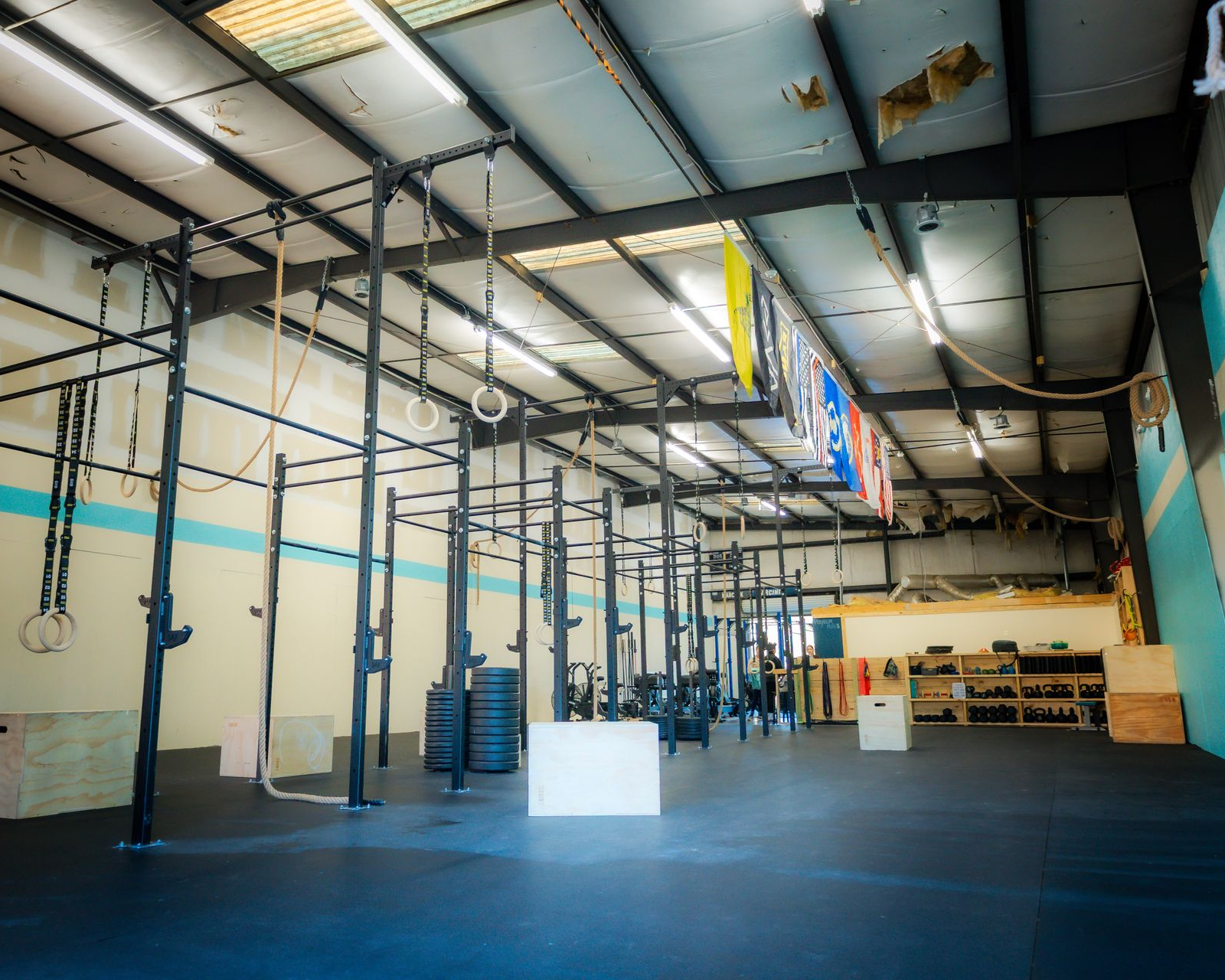 A gym with a lot of equipment and a lot of smoke coming out of the windows.