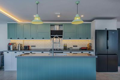 There is a large island in the middle of the kitchen.
