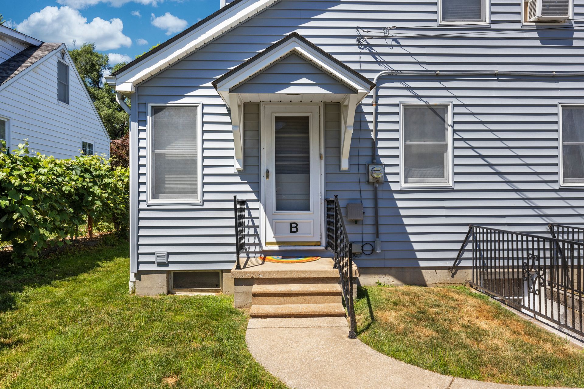 The front of a house with the letter b on the door