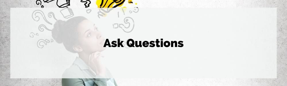 A woman is looking up at a bunch of question marks coming out of her head.
