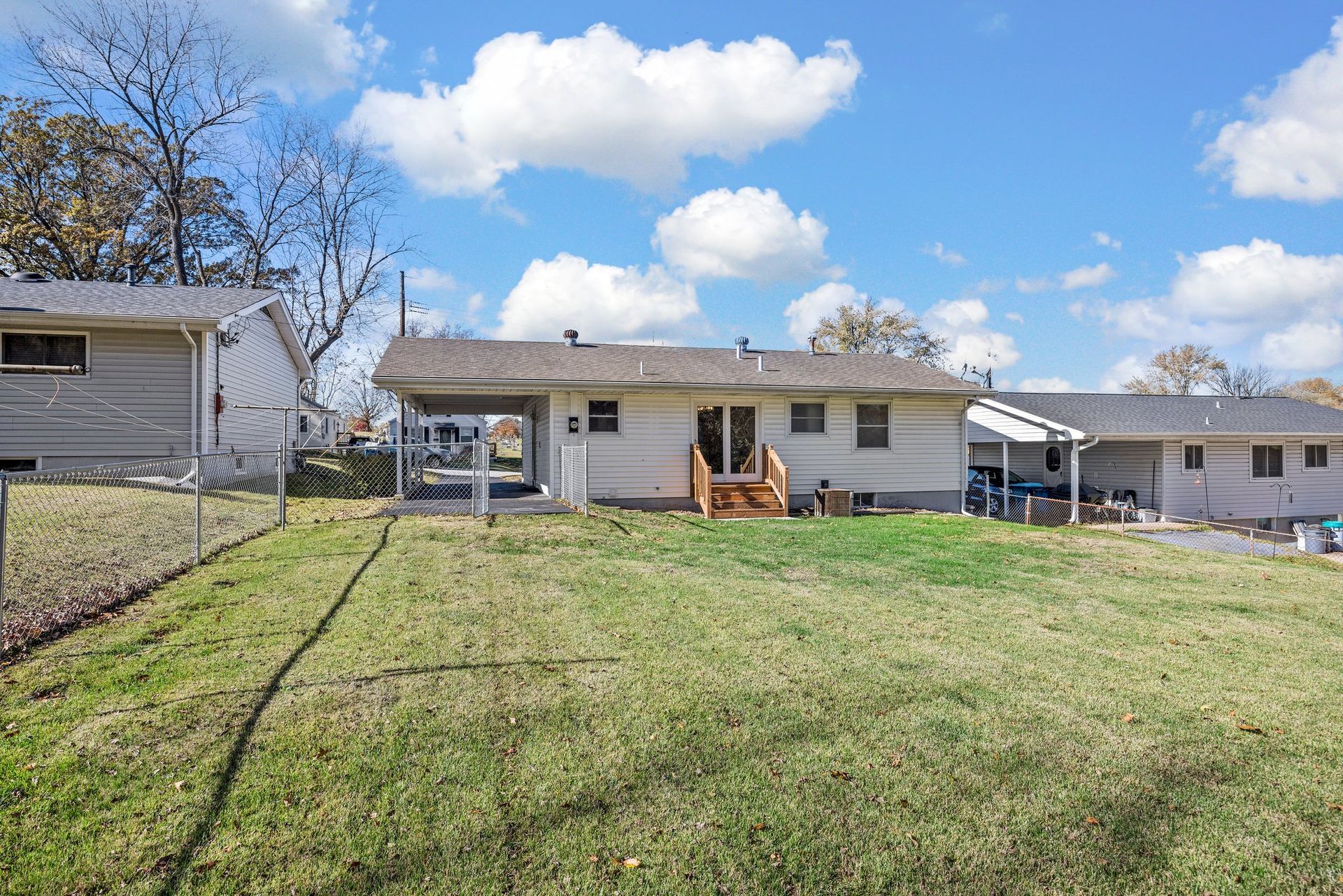 A house with a large lawn in front of it.
