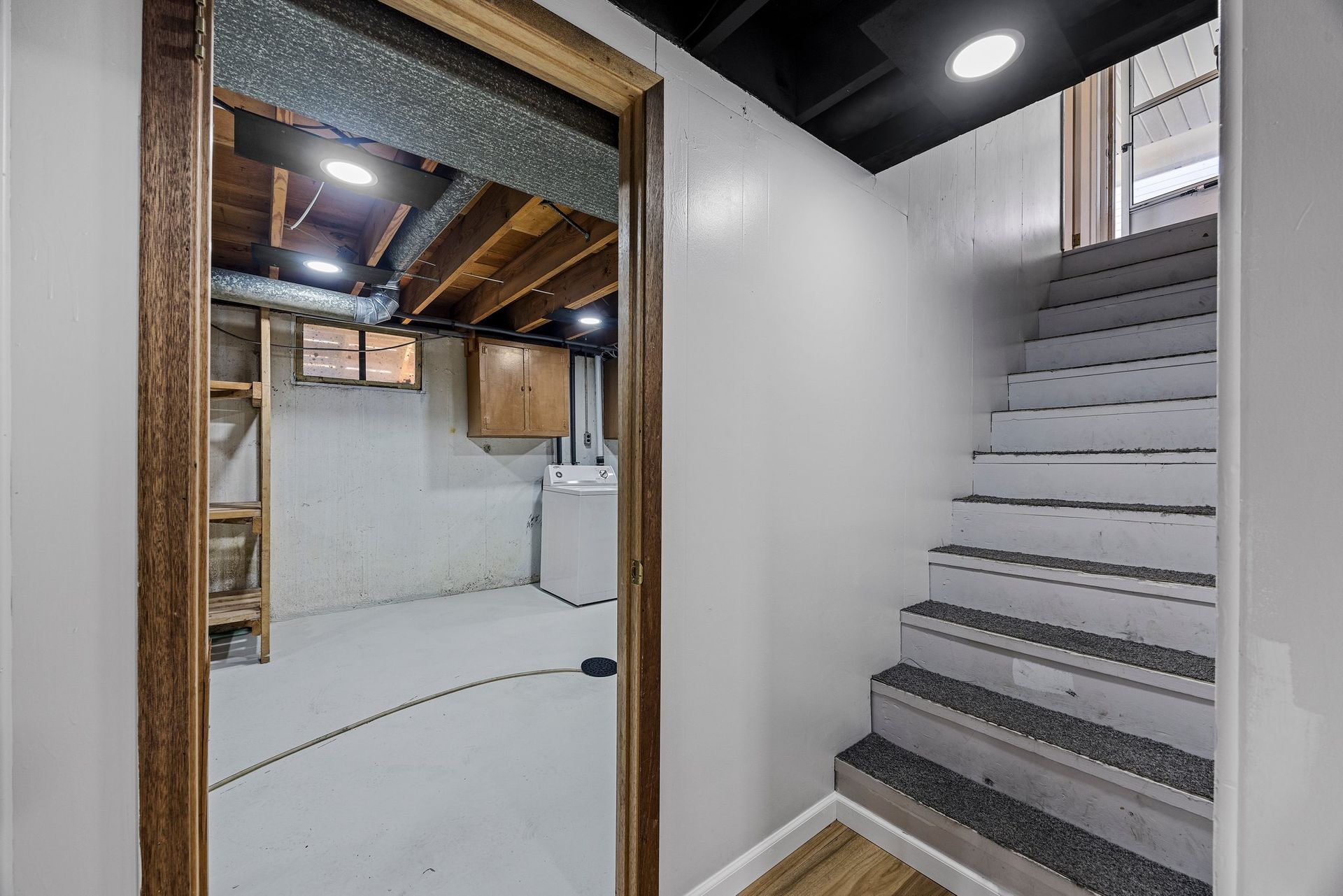 A basement with stairs leading up to the second floor.