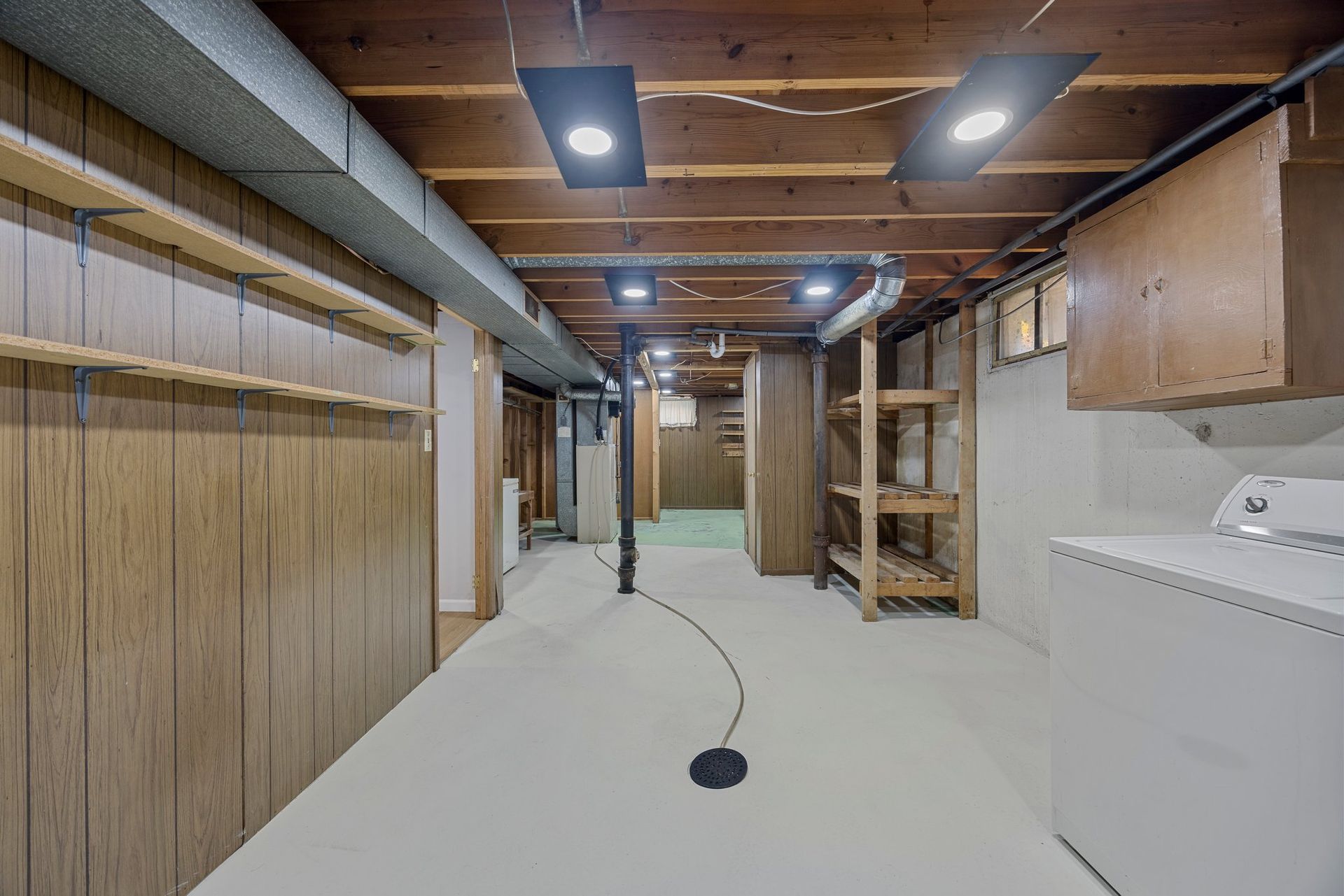 A basement with a washer and dryer in it.