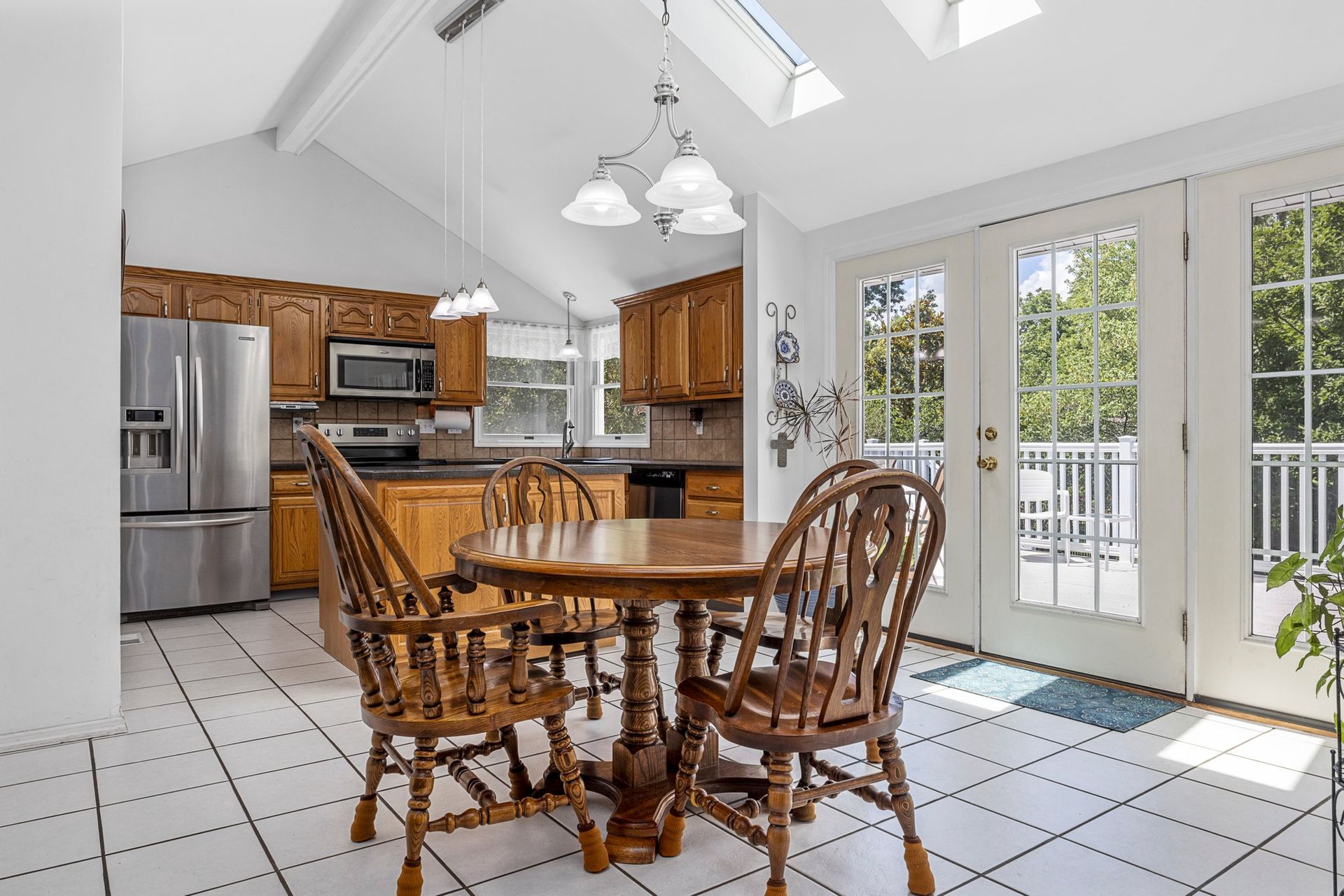 A kitchen with a table and chairs in it