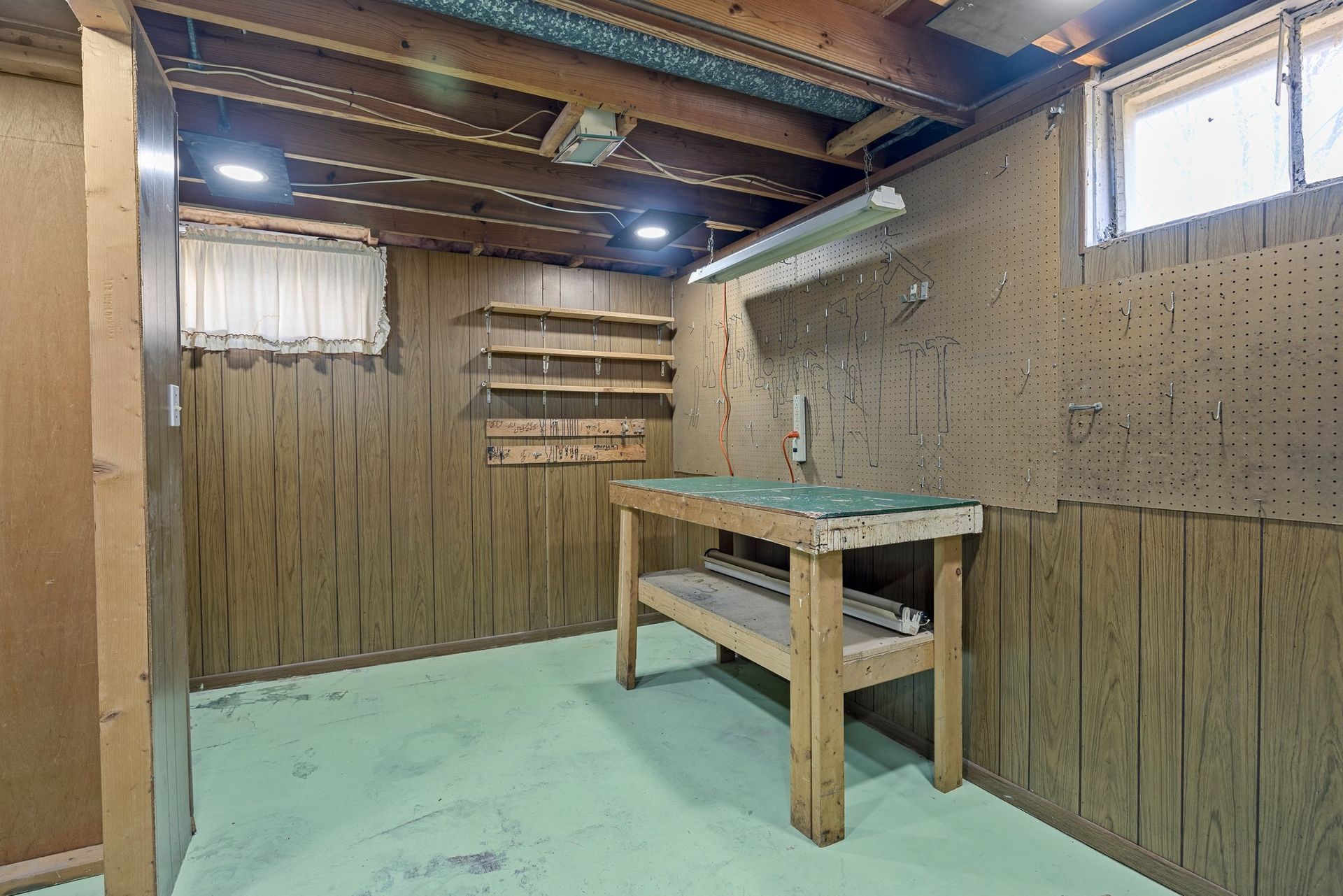 There is a wooden table in the middle of the room.