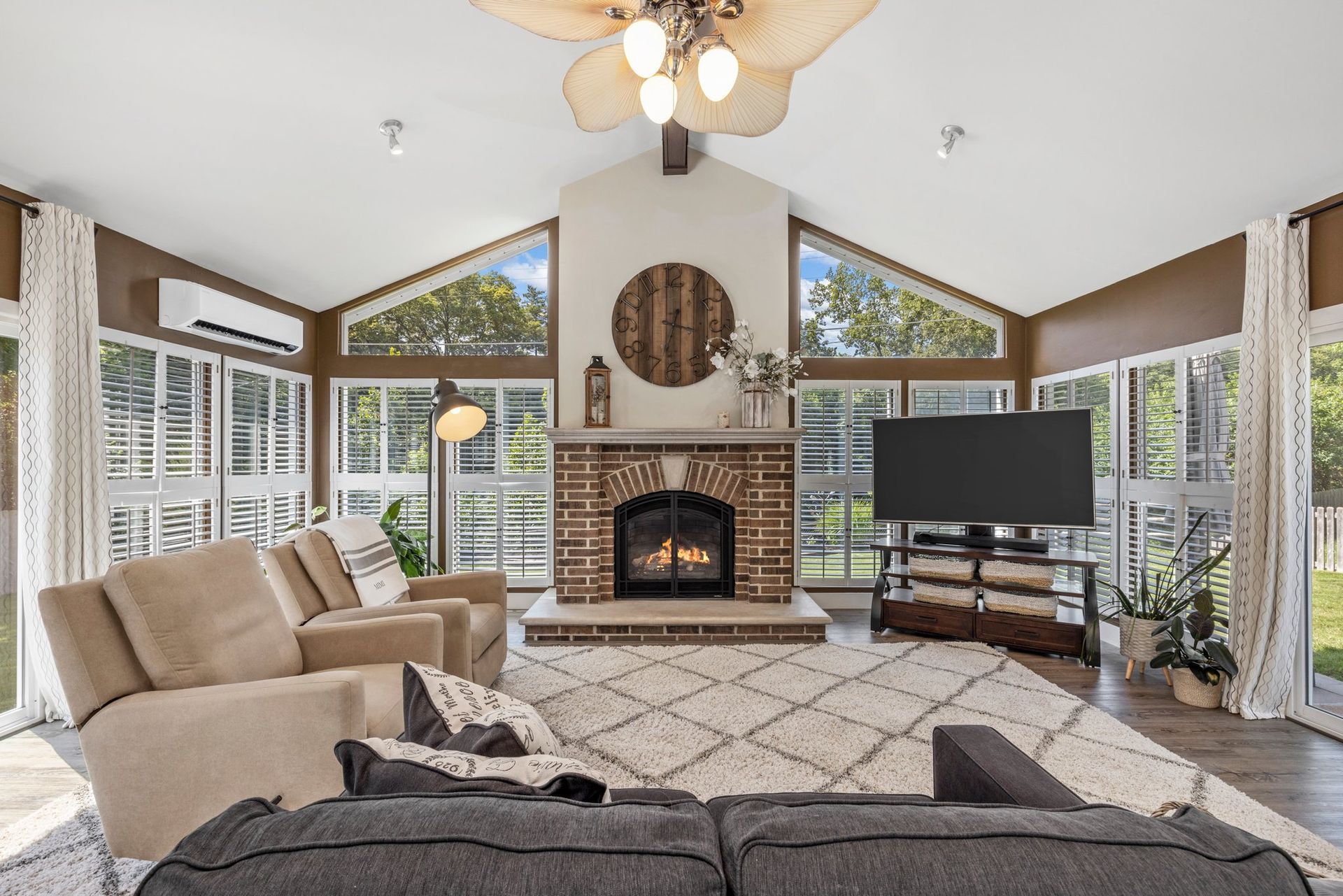 A living room with a fireplace and a flat screen tv.