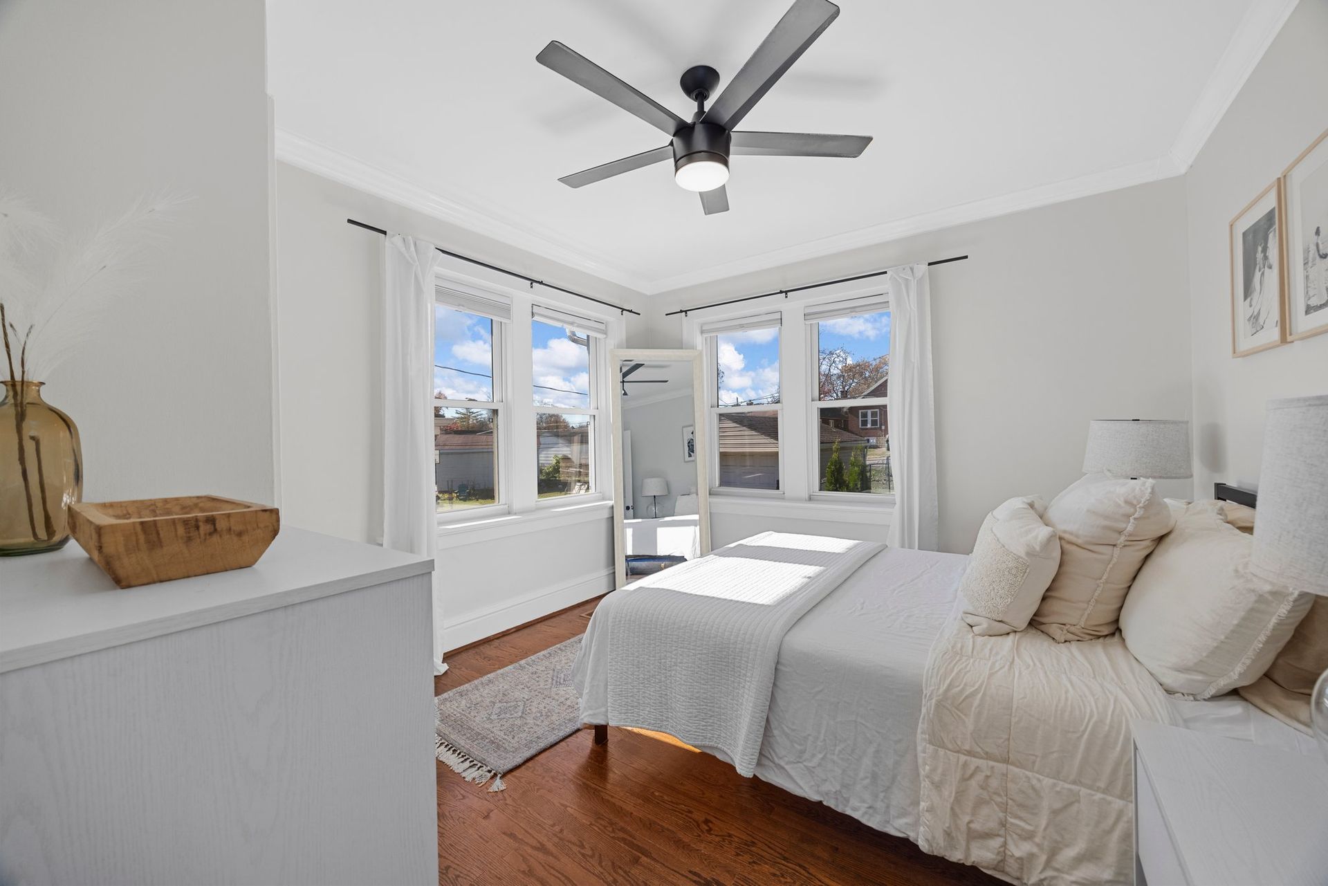 A bedroom with a bed and a ceiling fan.