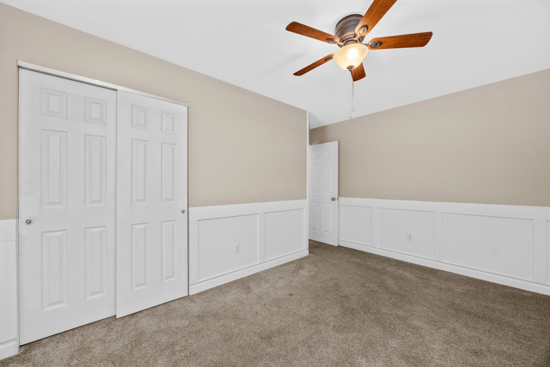 There is a ceiling fan in the corner of the room.