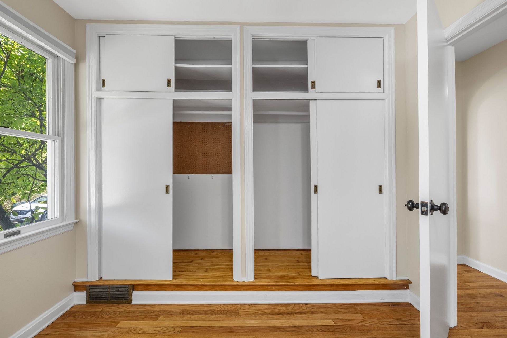 There is a closet in the middle of the room with sliding doors.