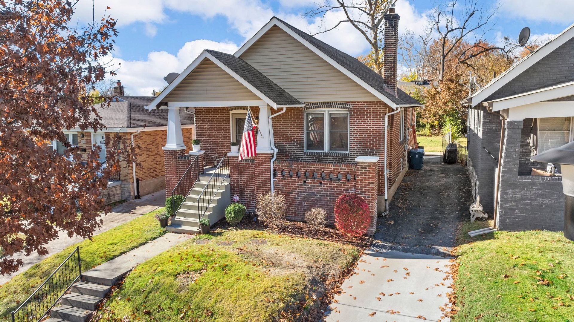 An aerial view of a house with a flag on the front porch.