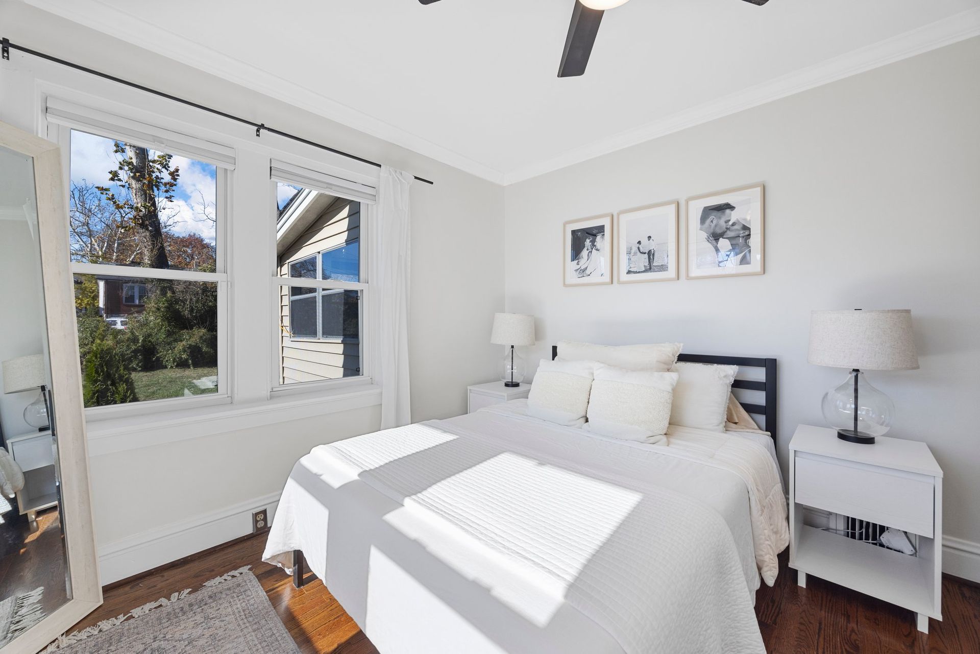 A bedroom with a large bed and a ceiling fan