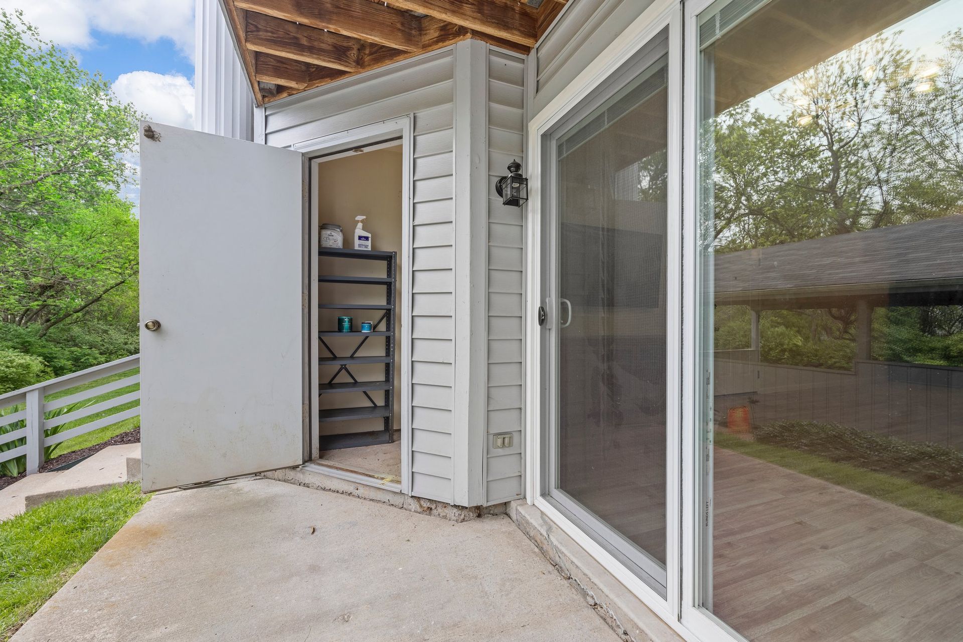 There is a sliding glass door leading to a shed.