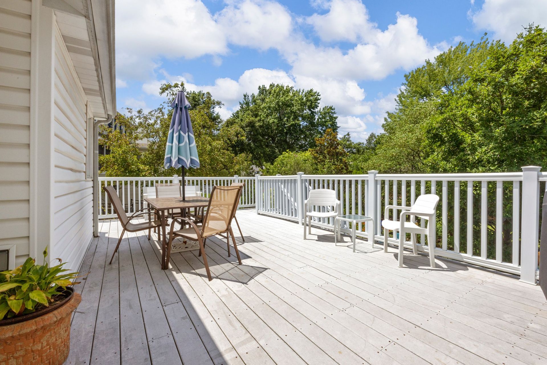 A large deck with a table and chairs on it