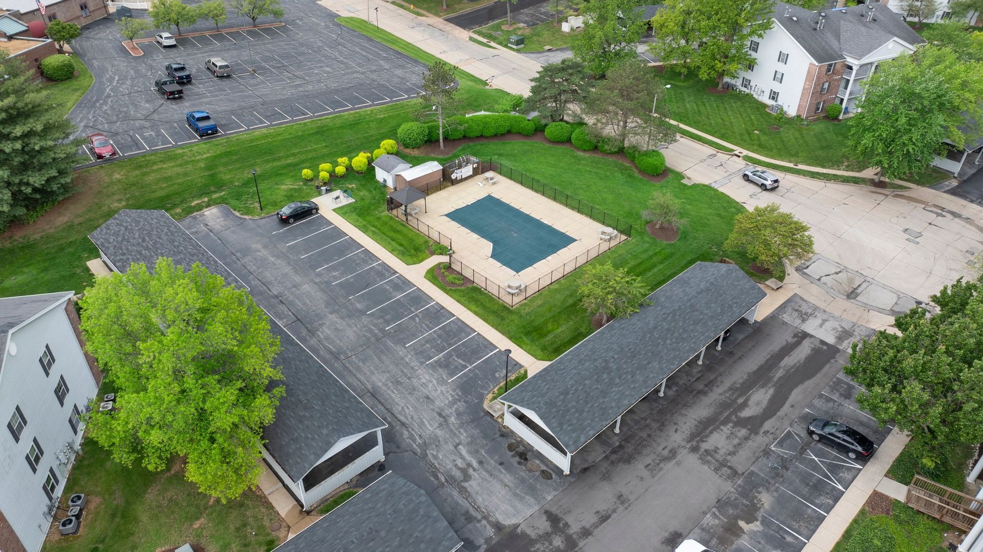 An aerial view of a swimming pool in a residential area