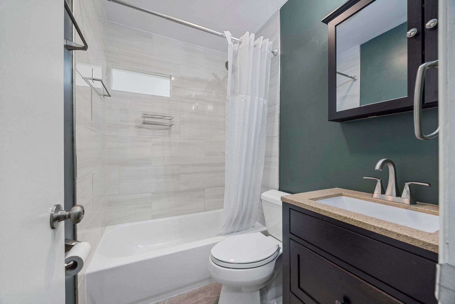 A bathroom with a toilet , sink , and shower.