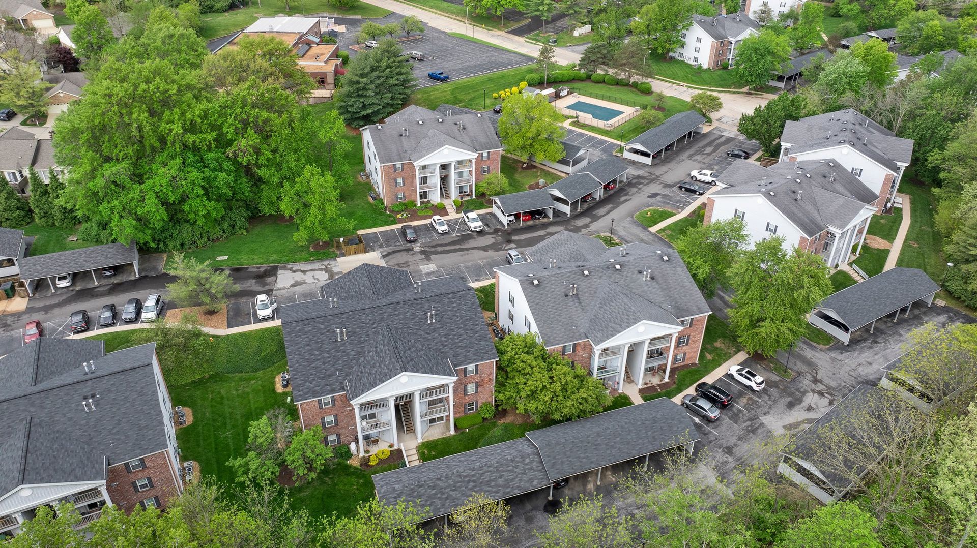 An aerial view of a residential area with lots of houses and trees