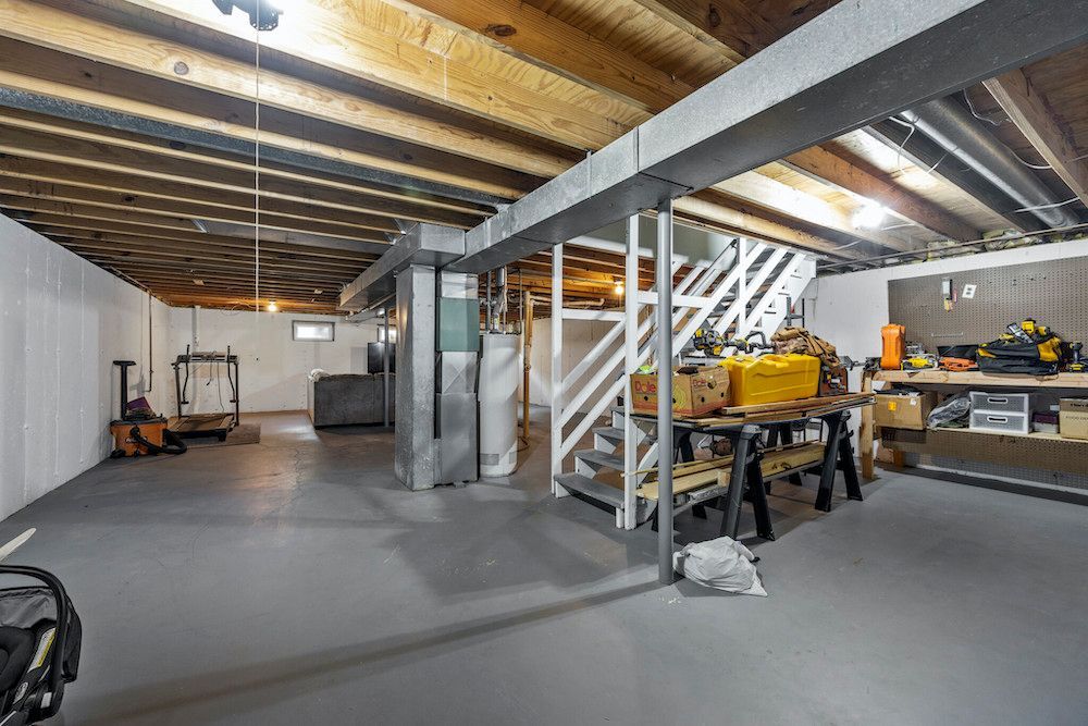 A large empty basement with a lot of tools in it.