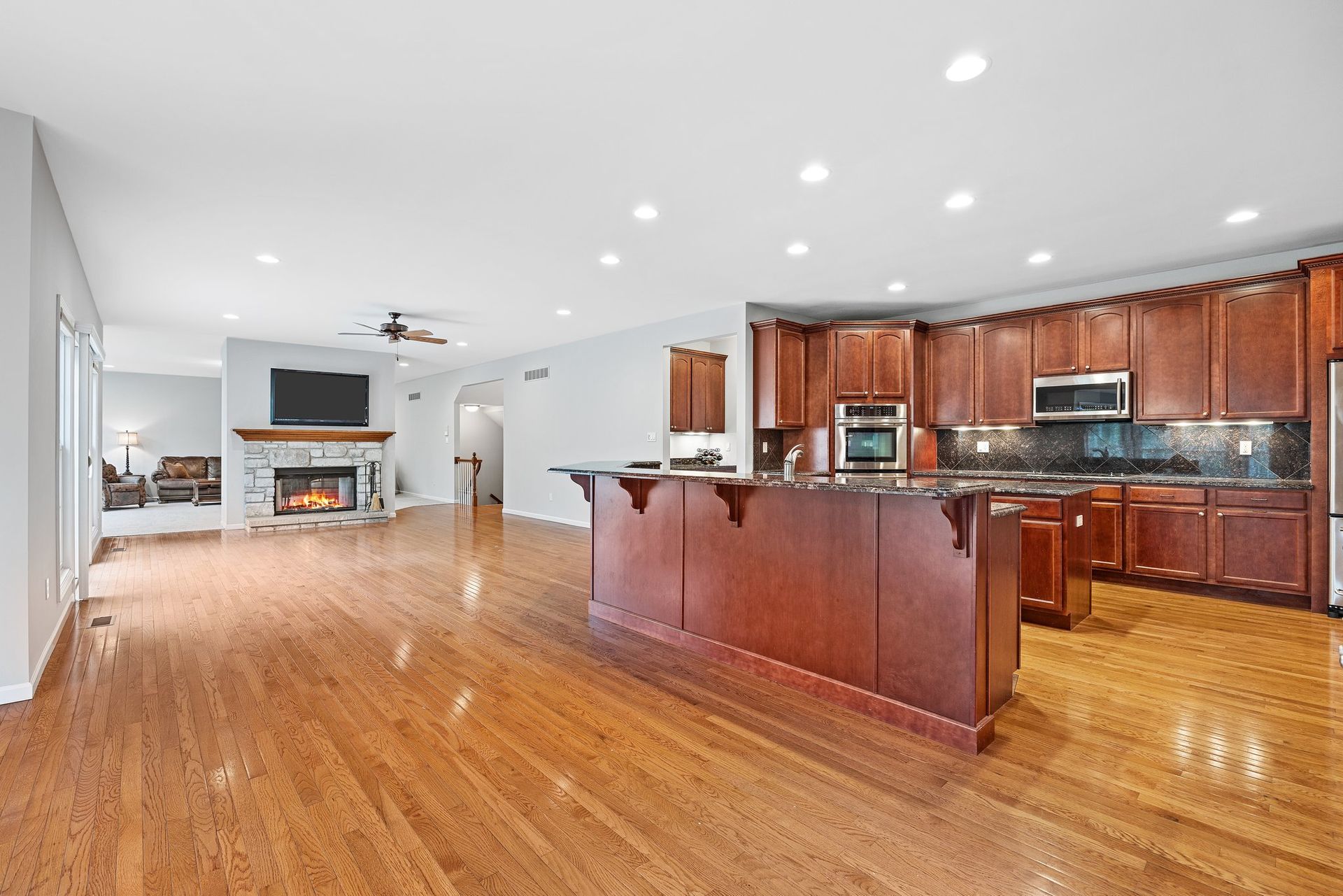 A large kitchen with hardwood floors and a large island.