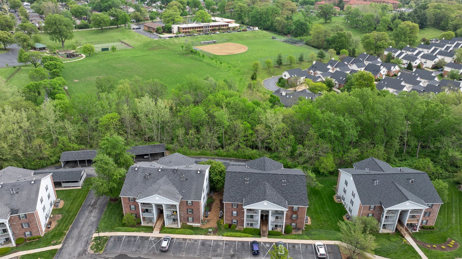 An aerial view of a residential area with houses and trees.