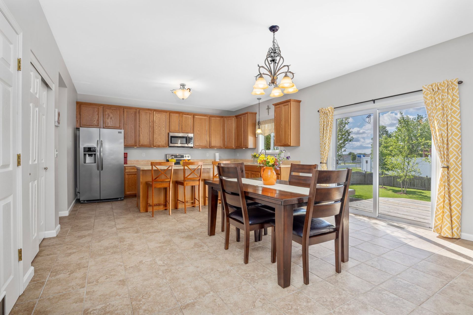A kitchen and dining room in a house with a table and chairs.