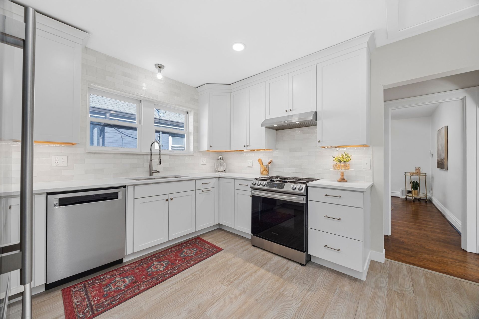 A kitchen with white cabinets and stainless steel appliances.