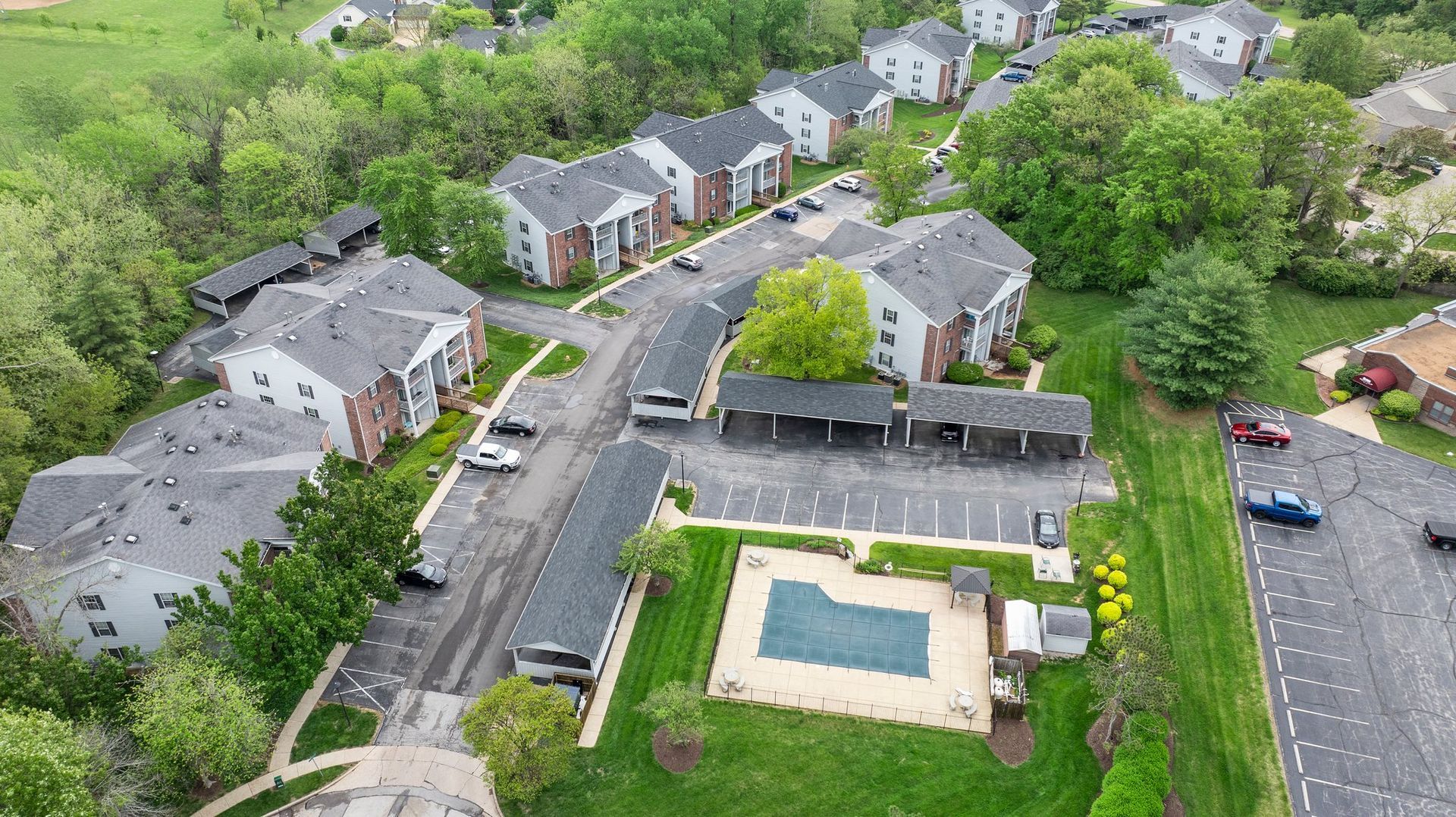 An aerial view of a residential area with a swimming pool.
