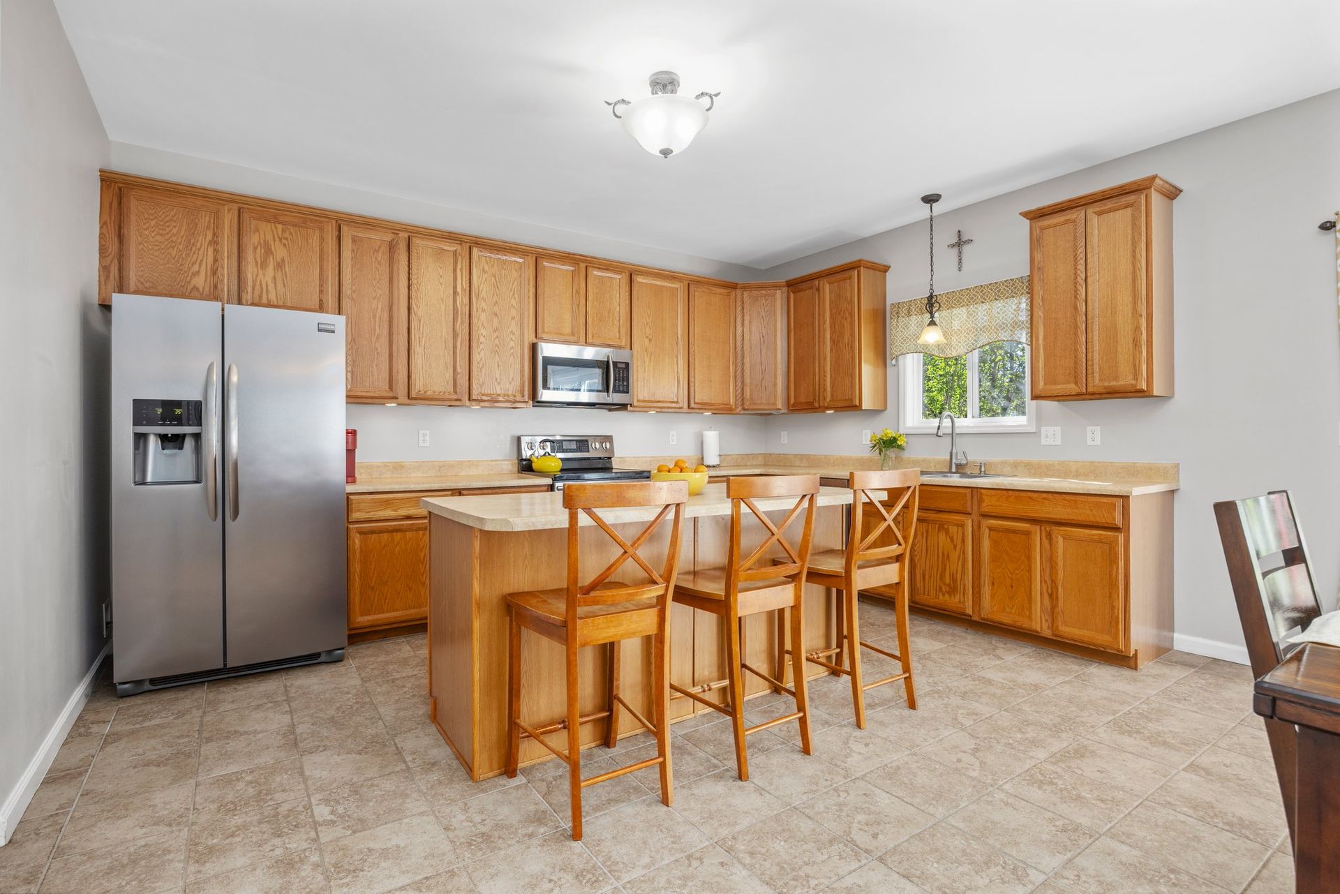 A kitchen with stainless steel appliances and wooden cabinets.